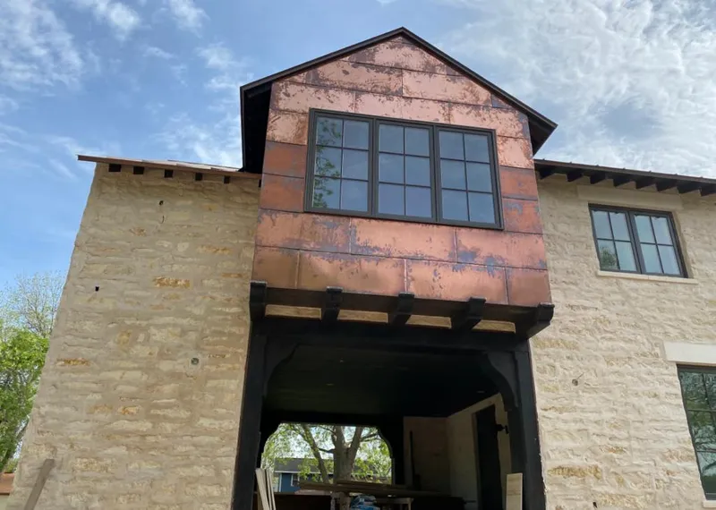 Copper metal panel facade on a stone building for Skylight Installation in Arkadelphia